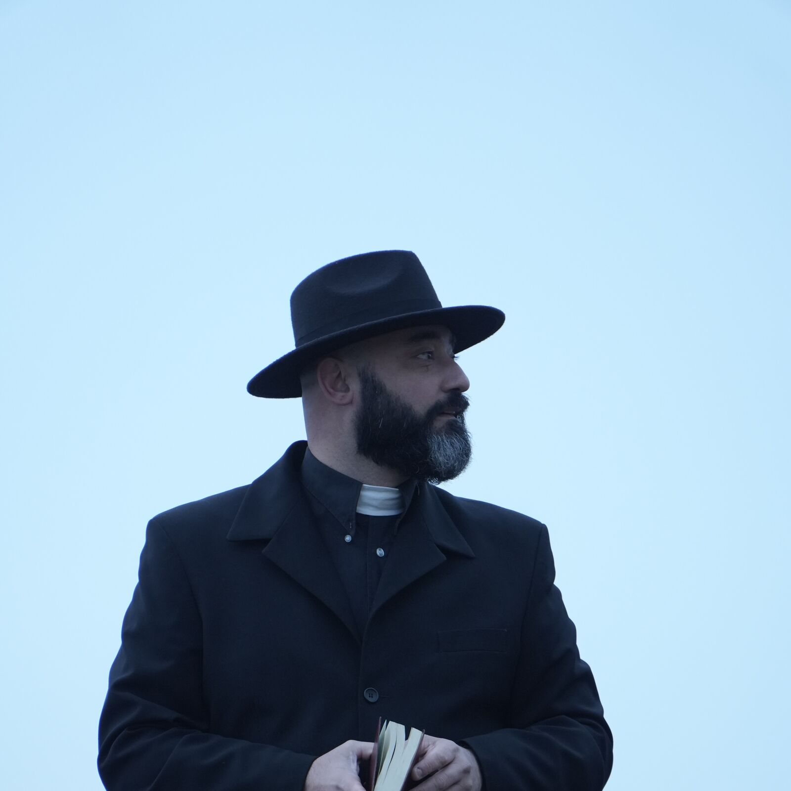 Mickaël TENA in the role of the priest.